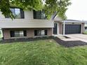 Charming two-story home with a well-manicured lawn and a two car garage at 8277 N Waterford Dr, Columbus, IN 47201