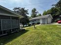 Quaint blue home with well-manicured lawn, small garden, and a bird bath at 8664 S Nash Dr, Nineveh, IN 46164