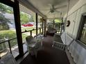 Relaxing screened porch with swing, chairs, ceiling fan, and neighborhood views at 8664 S Nash Dr, Nineveh, IN 46164