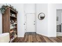 Bright entryway with wood floors, white walls, and stylish decor at 8753 Champions Dr, Indianapolis, IN 46256