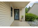 Covered front porch with decorative details, offering curb appeal and charm at 8753 Champions Dr, Indianapolis, IN 46256
