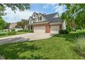 Beautiful two-story home with a well-maintained lawn, brick facade, and attached three-car garage at 8904 Carnation Dr, Noblesville, IN 46060