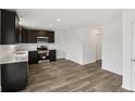 Spacious kitchen with stainless steel appliances, dark cabinetry, and wood-look flooring at 10416 Crystal Coop Ln, Indianapolis, IN 46235