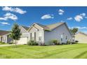 Side view of the house showcasing a well-maintained lawn and the home's siding at 1396 Lexington Trl, Greenfield, IN 46140