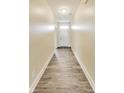 Inviting hallway with wood-look flooring leading to the front door at 1396 Lexington Trl, Greenfield, IN 46140