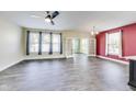 Spacious living room with modern flooring, a ceiling fan, and french doors at 1396 Lexington Trl, Greenfield, IN 46140