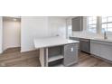 A close up of the kitchen island, complete with shelving, cabinet space and pristine white countertops at 14521 Hanford Ln, Carmel, IN 46074