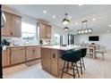 Bright kitchen featuring stainless steel appliances, a center island, and a dining area with modern lighting at 15192 Montfort Dr, Noblesville, IN 46062