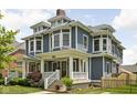 Charming two-story home with a well-manicured front yard and welcoming front porch at 1531 N College Ave, Indianapolis, IN 46202