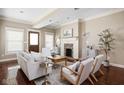 Cozy living room with a brick fireplace, neutral decor, and hardwood floors at 1531 N College Ave, Indianapolis, IN 46202