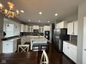 Modern kitchen featuring stainless steel appliances, granite countertops, a large island, and stylish pendant lighting at 15961 Foothill Dr, Noblesville, IN 46060