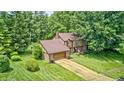 Beautiful aerial view of a suburban home surrounded by mature trees and lush green landscaping at 1660 Obara Ct, Carmel, IN 46033