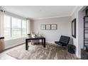 Inviting study with a large window, neutral tones, and stylish furniture creates a perfect work from home space at 17050 Daly Dr, Noblesville, IN 46062