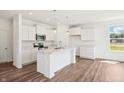 Bright and airy kitchen with white cabinets, stainless steel appliances, and marble countertops at 2151 Bear Oak Way, Shelbyville, IN 46176