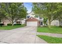 Attractive two-story home with a well-manicured lawn, mature trees and a spacious two-car garage at 2289 Salem Park Dr, Indianapolis, IN 46239