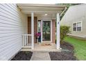 Cozy front porch with brick columns, decorative wreath on door, and a friendly 'hello' doormat at 2289 Salem Park Dr, Indianapolis, IN 46239