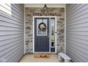 Close-up of the front door, showcasing the decorative wreath and stone surround at 2421 Creek Bank Dr, Columbus, IN 47201