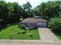 Aerial view of the charming gray home with a spacious front yard and inviting front deck at 2610 Caroline Ave, Indianapolis, IN 46218