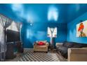 Bright blue living room with neutral furniture and a large patterned rug at 2610 Caroline Ave, Indianapolis, IN 46218