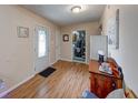 Entryway with wood-look floors, traditional door, and view of an adjacent utility space at 3025 Sable Ridge Ln, Greenwood, IN 46142