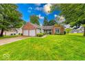 Charming single-story brick home featuring an attached two-car garage and a lush green front yard at 3025 Sable Ridge Ln, Greenwood, IN 46142