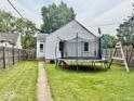 Fenced yard with large trampoline and swing set, perfect for Gathering fun at 313 S Brittain Ave, Muncie, IN 47303