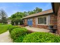 Brick ranch home featuring a charming front entrance with blue double doors and tidy landscaping at 3707 E Wilson Dr, Mooresville, IN 46158