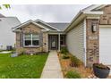 Inviting front exterior featuring a walkway leading to the front door, enhanced by well-manicured landscaping at 3872 Dusty Sands Rd, Whitestown, IN 46075