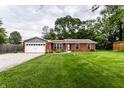 Well maintained single-story brick home featuring a manicured front lawn with tidy landscaping and an attached two-car garage at 4191 N Graham Rd, Whiteland, IN 46184