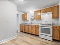 Modern kitchen features wood cabinets, granite counters, and white appliances at 4310 Crittenden Ave, Indianapolis, IN 46205