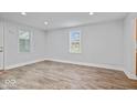 Bright living room featuring modern wood-look flooring, fresh white walls, and recessed lighting at 4310 Crittenden Ave, Indianapolis, IN 46205