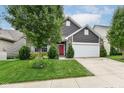 Charming home with a red door, manicured lawn, and attached two-car garage on a sunny day at 561 Farnham Dr, Westfield, IN 46074