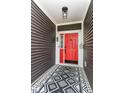 Stylish front entry featuring a red door, modern light fixture, and decorative black-and-white patterned rug at 561 Farnham Dr, Westfield, IN 46074