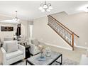 Open-concept living area with views into the dining room; neutral paint and hardwood floors at 6691 Beekman Pl, Zionsville, IN 46077