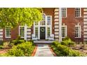 Elegant front entrance with a dark door, transom window, and welcoming white chairs at 7341 Washington Blvd, Indianapolis, IN 46240