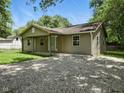 Single-story home with vinyl siding, a gravel driveway, and a covered porch entry at 7434 N Green Meadows, Fairland, IN 46126