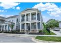 Charming two-story home with large front porch, white columns, fenced in yard and blue siding at 776 Templeton Dr, Carmel, IN 46032