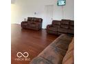Spacious living room featuring hardwood floors and comfortable leather seating at 8113 Maple Stream Ln, Indianapolis, IN 46217