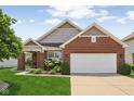 Charming single-Gathering home with a brick facade, well-manicured lawn, and a two-car garage in a suburban neighborhood at 8115 Cole Wood Blvd, Indianapolis, IN 46239