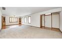 Open living space featuring neutral carpet, white walls, and natural light from many windows at 817 S Jefferson St, Brownsburg, IN 46112