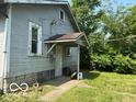 Side view of house with backyard access and showing the unique construction design at 822 W 7Th St, Muncie, IN 47302
