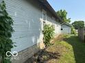 Side view of the house and backyard including the garage at 822 W 7Th St, Muncie, IN 47302