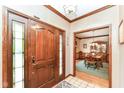 Inviting home foyer with hardwood floors, decorative trim, and views into the dining room at 8534 Helmsman Cir, Indianapolis, IN 46256