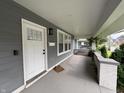 View of the home's front porch with a white front door and exterior light at 917 N Rural St, Indianapolis, IN 46201