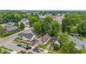 A slightly higher aerial perspective captures the home’s position amidst tree-lined streets and a mix of residential buildings at 1011 W 7Th St, Anderson, IN 46016