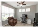 Bright home office featuring carpet, natural light, gray walls, a ceiling fan, and a comfortable chair at 10334 Deercrest Ln, Indianapolis, IN 46239