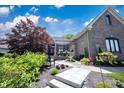 Beautiful home featuring a meticulously landscaped front yard with a fountain and covered entrance at 10707 Burning Ridge Ln, Fishers, IN 46037