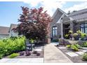 Attractive brick home with a beautifully landscaped front yard, featuring a water fountain and comfortable bench seating at 10707 Burning Ridge Ln, Fishers, IN 46037