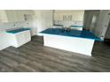 Spacious kitchen featuring an island, modern cabinets, durable floors, and stainless steel sink ready for customization at 1175 Mcbride St, Greenfield, IN 46140