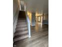 Inviting foyer featuring staircase and modern flooring that flows into the living area at 12639 Justice Xing, Fishers, IN 46037